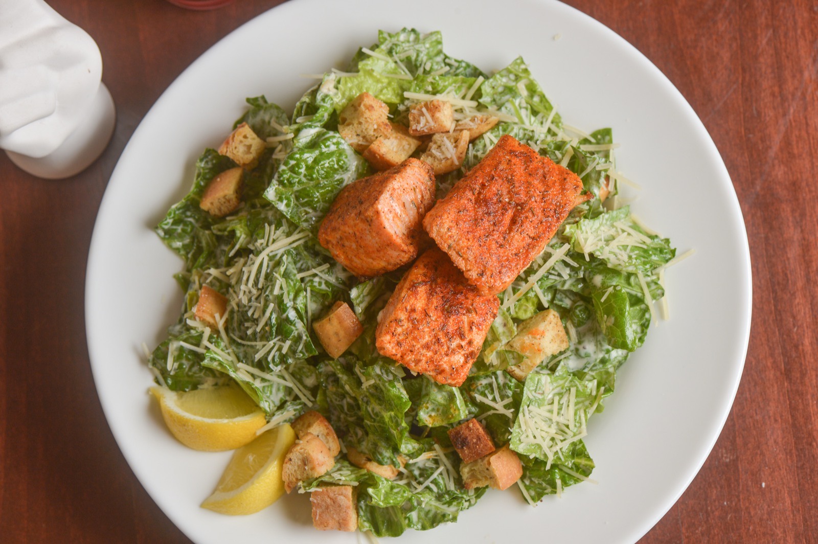 Blackened salmon over a Caesar salad with shaved parmesan, croutons and lemon.